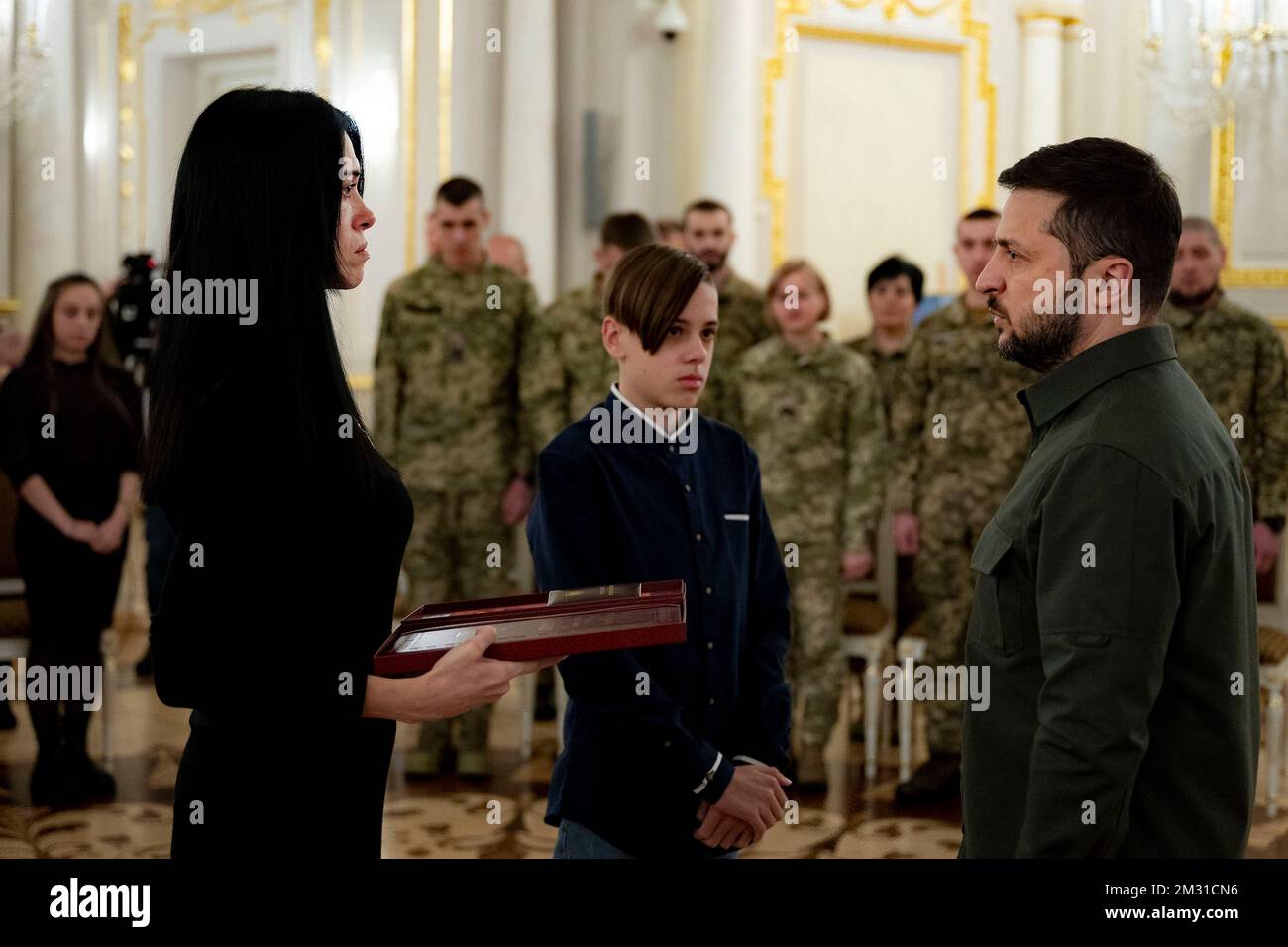 Kyiv, Ukraine. 12 December, 2022. Ukrainian President Volodymyr Zelenskyy, right, presents state awards to families of soldiers killed in action during an award ceremony on the Day of the Ground Forces in the White Hall of Heroes of the Mariyinsky Palace, December 12, 2022 in Kyiv, Ukraine.  Credit: Ukraine Presidency/Ukrainian Presidential Press Office/Alamy Live News Stock Photo