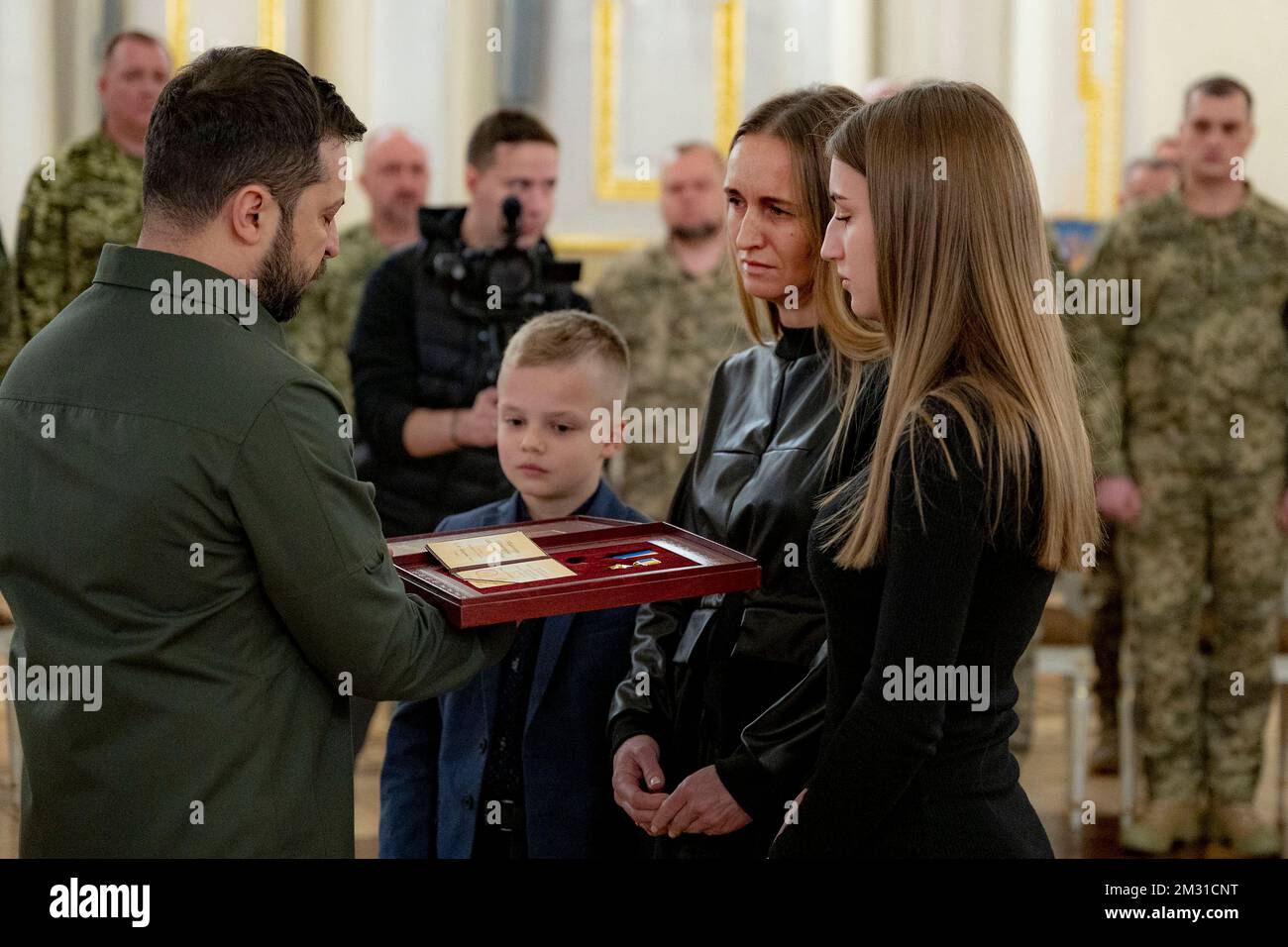 Kyiv, Ukraine. 12 December, 2022. Ukrainian President Volodymyr Zelenskyy, left, presents state awards to families of soldiers killed in action during an award ceremony on the Day of the Ground Forces in the White Hall of Heroes of the Mariyinsky Palace, December 12, 2022 in Kyiv, Ukraine.  Credit: Ukraine Presidency/Ukrainian Presidential Press Office/Alamy Live News Stock Photo