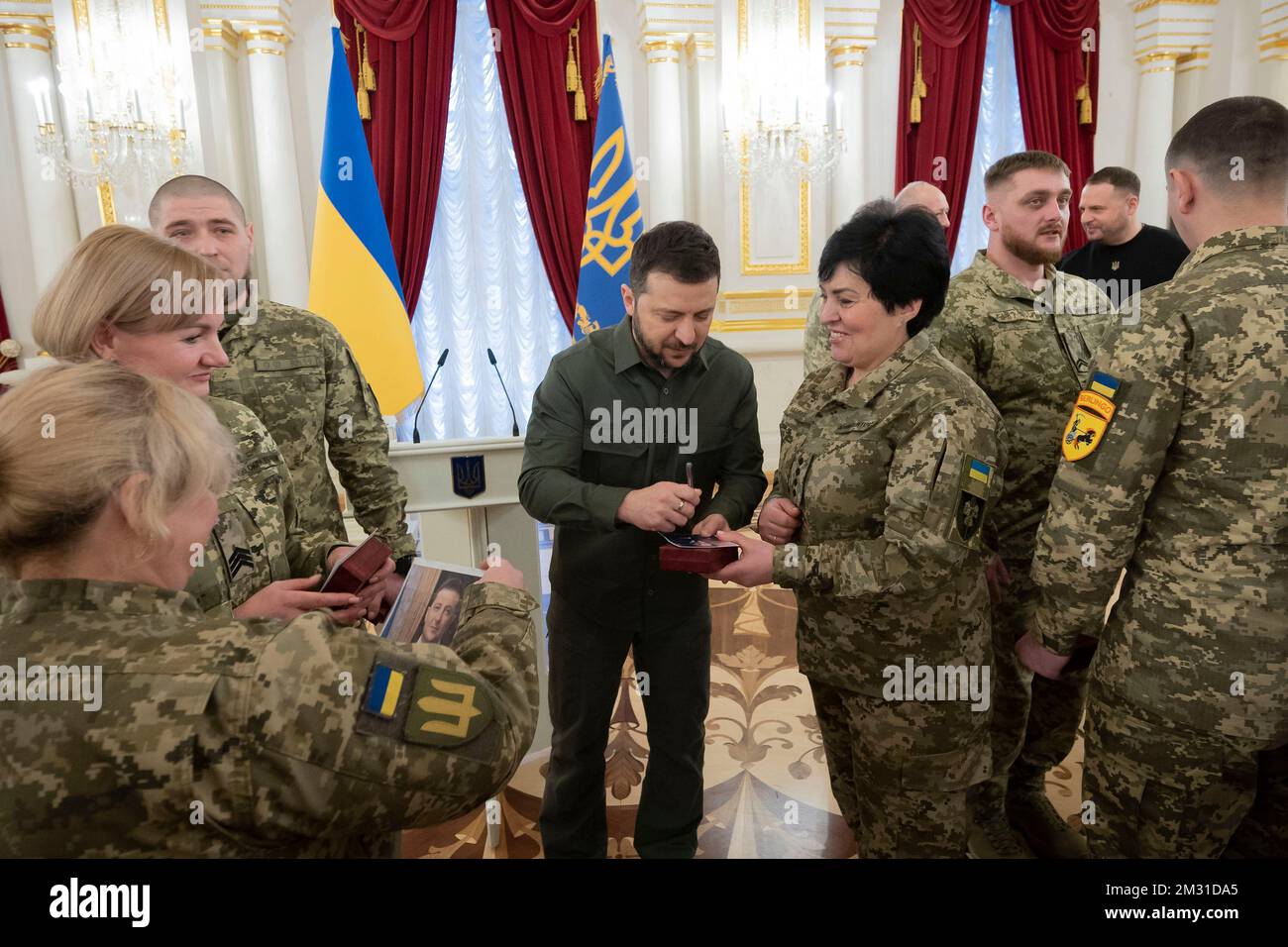 Kyiv, Ukraine. 12 December, 2022. Ukrainian President Volodymyr Zelenskyy, center, signs autographs for soldiers following an award ceremony on the Day of the Ground Forces in the White Hall of Heroes of the Mariyinsky Palace, December 12, 2022 in Kyiv, Ukraine.  Credit: Ukraine Presidency/Ukrainian Presidential Press Office/Alamy Live News Stock Photo