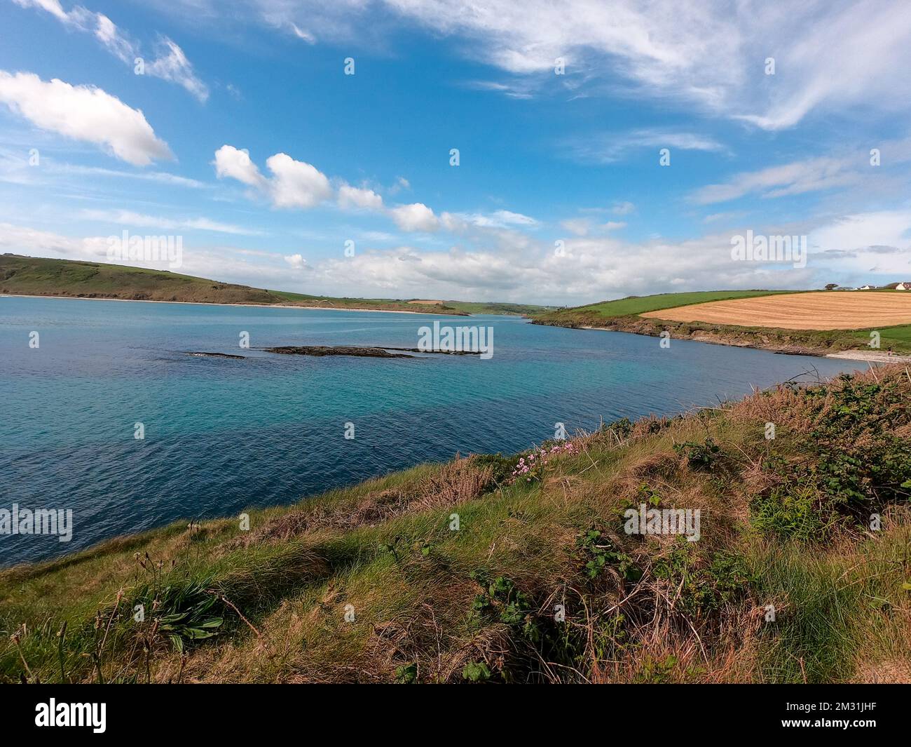 Celtic Sea Bay near Clonakilty, Ireland. Beautiful seascape. Blue sky with white clouds. Coastal nature. Stock Photo