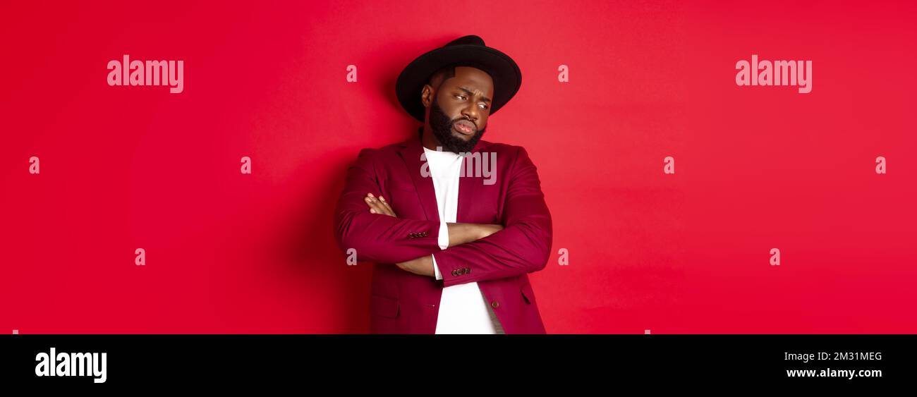 Red Offend Reluctant and upset african american man looking away, cross arms on ...