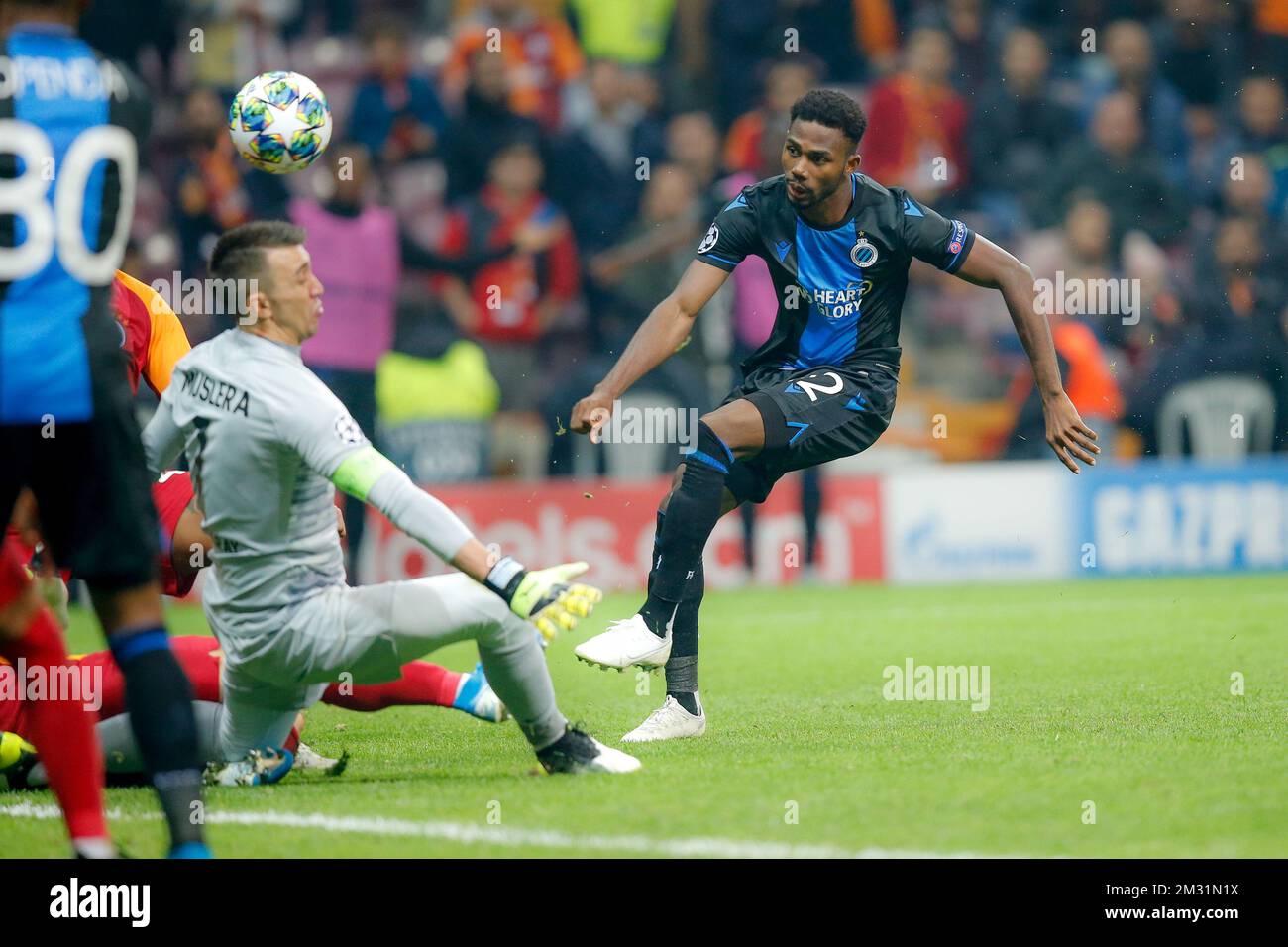 Galatasaray's Fernando Muslera and Club's Emmanuel Bonaventure Dennis fight for the ball during a game between Turkish club Galatasaray and Belgian soccer team Club Brugge, Tuesday 26 November 2019 in Istanbul, Turkey, fifth match in Group A of the UEFA Champions League. BELGA PHOTO BRUNO FAHY Stock Photo