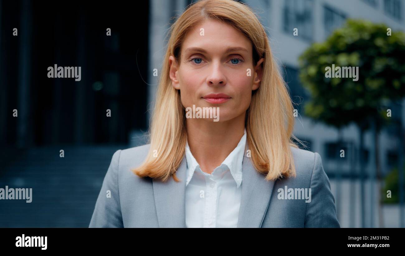 Female portrait young successful caucasian businesswoman blonde in formal suit looking at camera confident proud serious woman professional manager Stock Photo