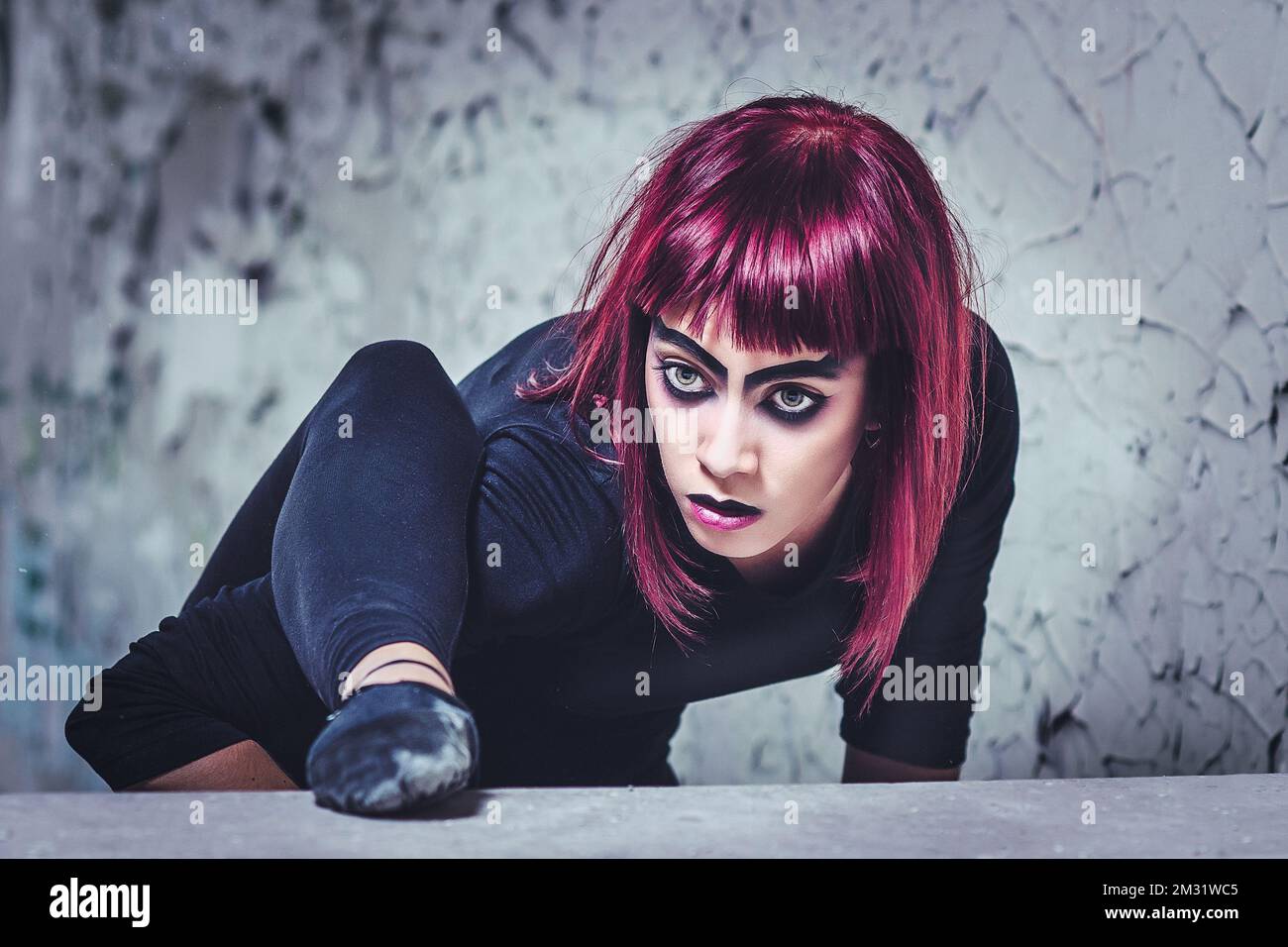 girl model in black with pink hair in an abandoned building Stock Photo