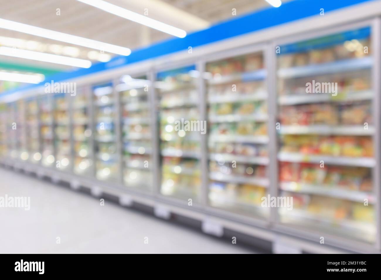 supermarket commercial refrigerators freezer showing frozen foods abstract blur background Stock Photo