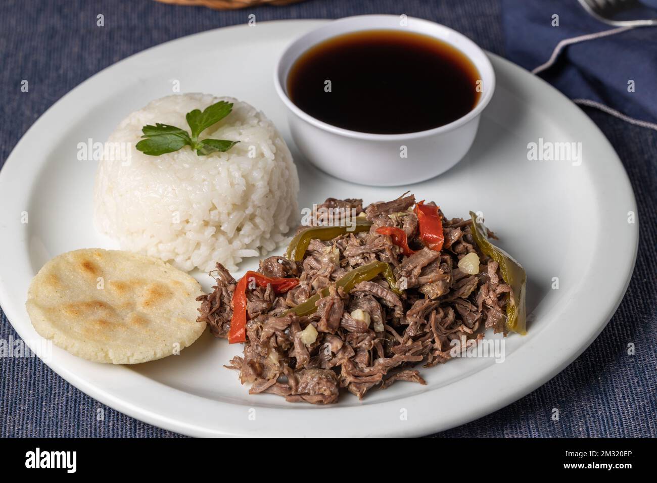 Shredded meat with rice, typical Cuban food on white plate. Stock Photo