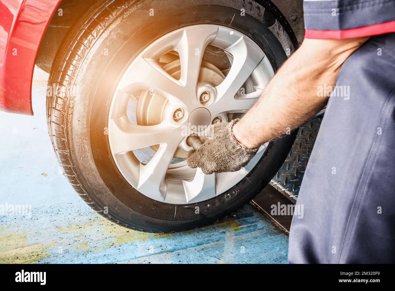 Tire replacement service, Mechanic with wrench working at auto repair ...