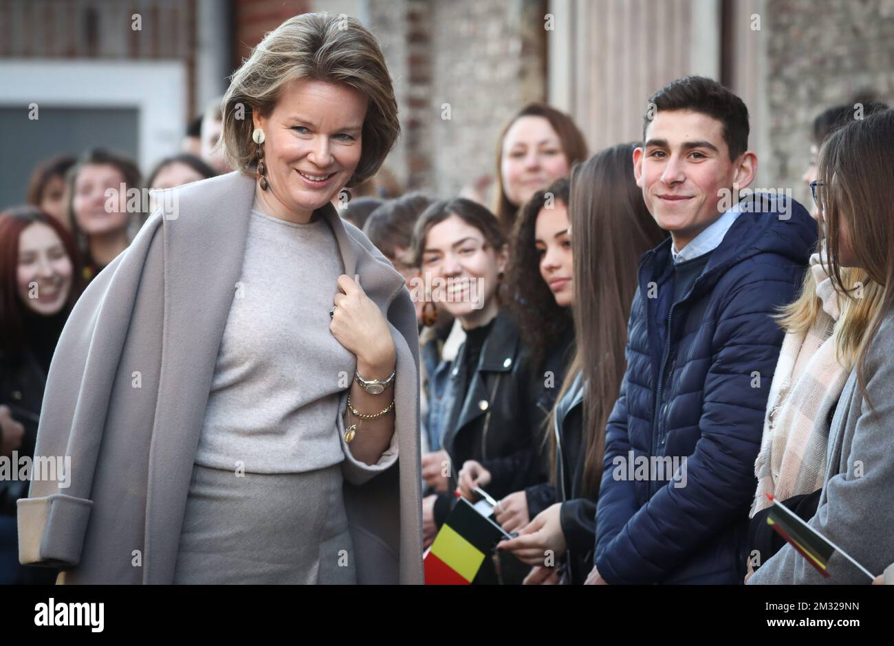 Queen Mathilde of Belgium meets children during a royal visit to the secondary school Sainte