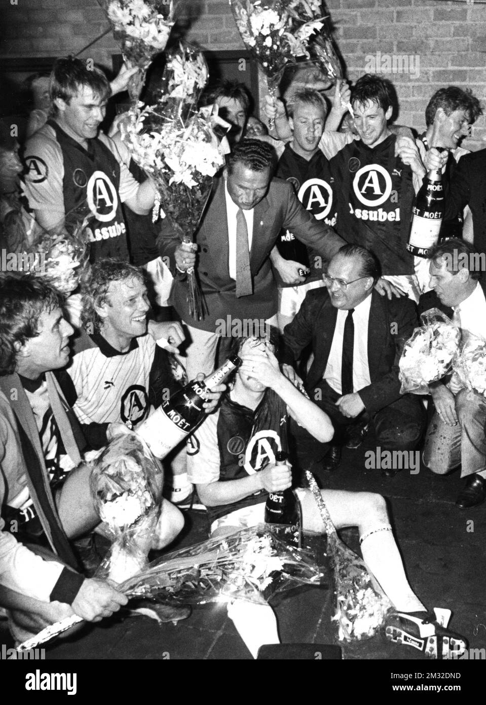Club Brugge soccer team feasting after they won the match agains Winterslag 3-0 and becoming Campion for the 87/88 season, in the middle with glasses, is transport minister Dehaene , Sunday 15 May 1988. BELGA PHOTO ARCHIVES  Stock Photo