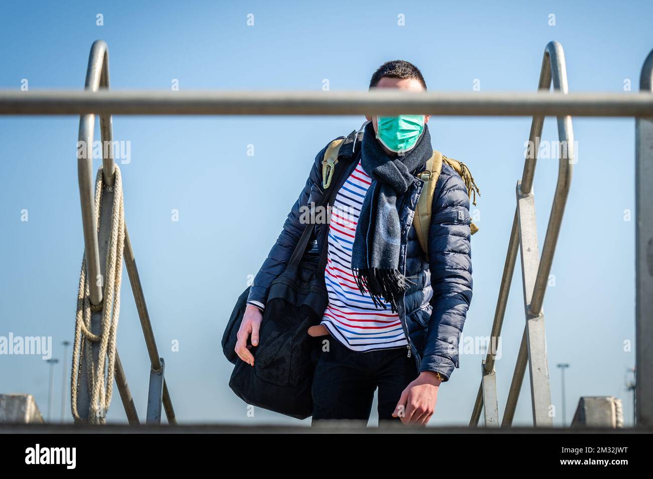 ATTENTION EDITORS - HAND OUT PICTURES - EDITORIAL USE ONLY - MANDATORY CREDIT HANDOUT DEFENSIE - DEFENCE TBN JORN URBAIN A person wearing a mouth mask pictured at the arrival of Belgian frigate Leopold 1 in Zeebrugge, Friday 27 March 2020. One of the sailors on the frigate has a confirmed Corona virus infection and has left the ship earlier. Due to the strict measures following such an infection, the ship has returned earlier from its mission and all non-infected sailors must now stay in home quarantine. BELGA PHOTO HANDOUT DEFENSIE - DEFENCE TBN JORN URBAIN  Stock Photo