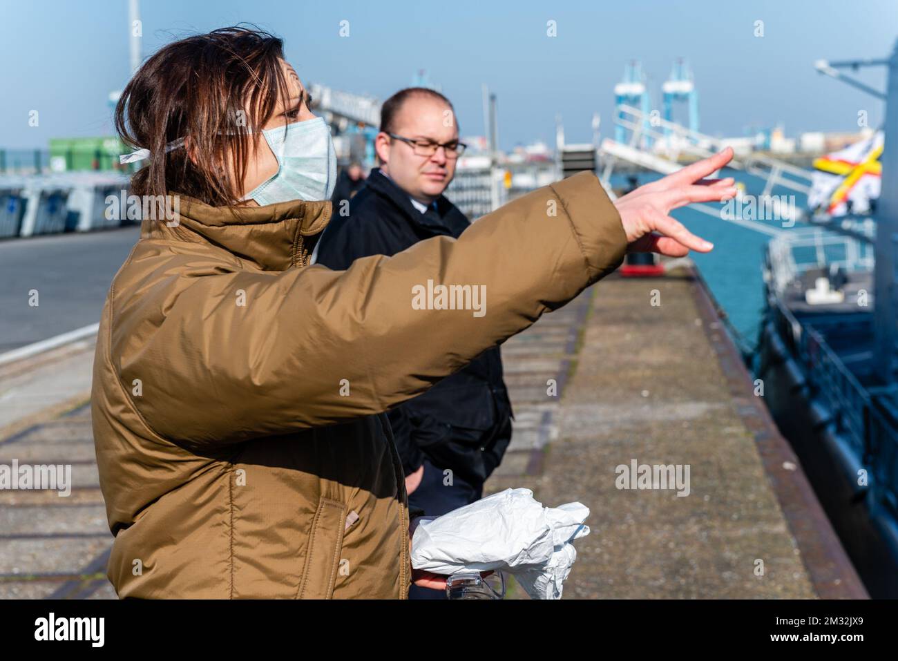 ATTENTION EDITORS - HAND OUT PICTURES - EDITORIAL USE ONLY - MANDATORY CREDIT HANDOUT DEFENSIE - DEFENCE TBN JORN URBAIN A woman wearing a mouth mask, pictured at the arrival of Belgian frigate Leopold 1 in Zeebrugge, Friday 27 March 2020. One of the sailors on the frigate has a confirmed Corona virus infection and has left the ship earlier. Due to the strict measures following such an infection, the ship has returned earlier from its mission and all non-infected sailors must now stay in home quarantine. BELGA PHOTO HANDOUT DEFENSIE - DEFENCE TBN JORN URBAIN  Stock Photo