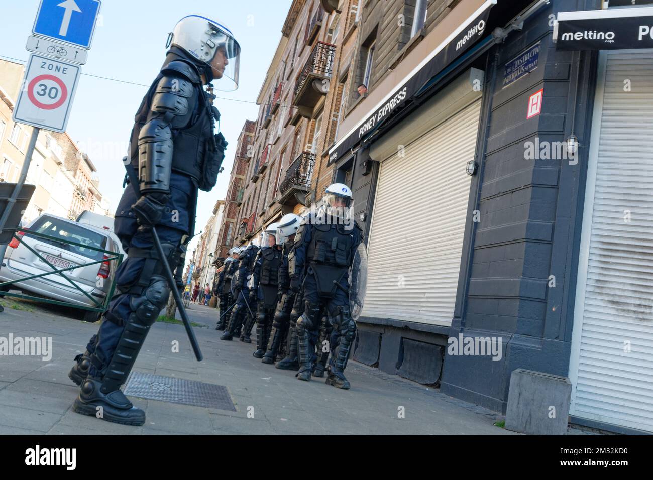 Police wearing protective gear pictured at the site of riots in ...