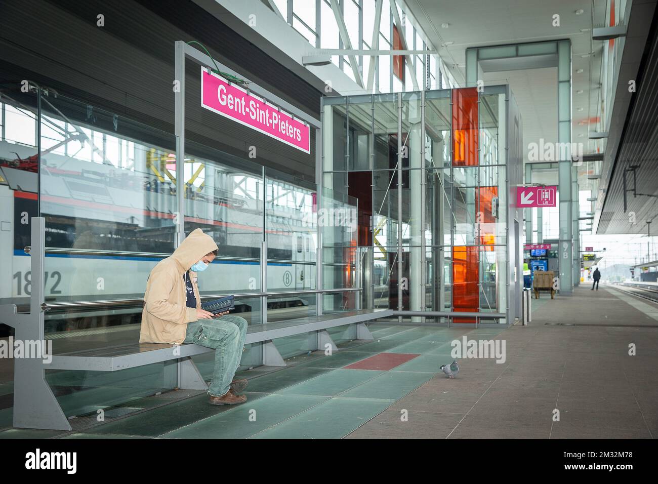 Illustration picture shows a traveller wearing a mouth mask as he waits for  a train, at Gent Sint-Pieters railway station, Monday 04 May 2020. From  today on, wearing a mask that covers
