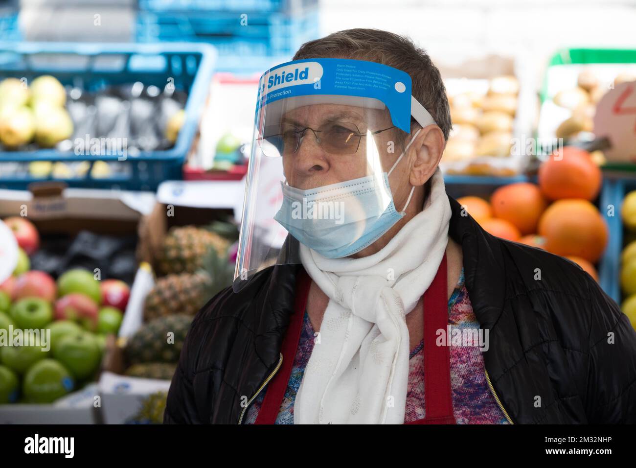 Illustration picture shows a fruits and vegetable sales woman wearing a mouth mask and a face shield, at the open-air market 'Marche de la Batte', Belgium's biggest market, in Liege, Sunday 24 May 2020. Belgium is in its tenth week of confinement in the ongoing corona virus crisis, different sectors of the public life are gradually reopening. BELGA PHOTO NICOLAS MAETERLINCK Stock Photo