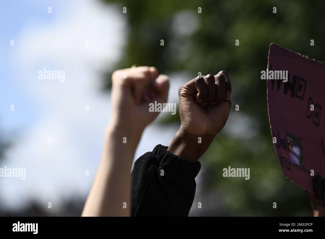 A white and black fist pictured during an anti-racism protest, part of the Black Lives Matter protests, in Antwerp, Sunday 07 June 2020. Accross Belgium, several BLM - protests are organised, in support of the protests and anti-racism movement in the USA, following the death of George Floyd, an innocent black man killed by a white police officer. BELGA PHOTO DIRK WAEM  Stock Photo