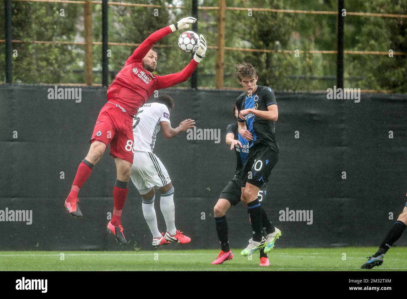 Club's goalkeeper Simon Mignolet, OHL's Pierre Yves Ngawa and Club's Charles De Ketelaere fight for the ball during a friendly game between first league team Club Brugge and 1B team OH Leuven, Saturday 04 July 2020 in Westkapelle, in preparation of the upcoming 2020-2021 Jupiler Pro League season. BELGA PHOTO BRUNO FAHY Stock Photo