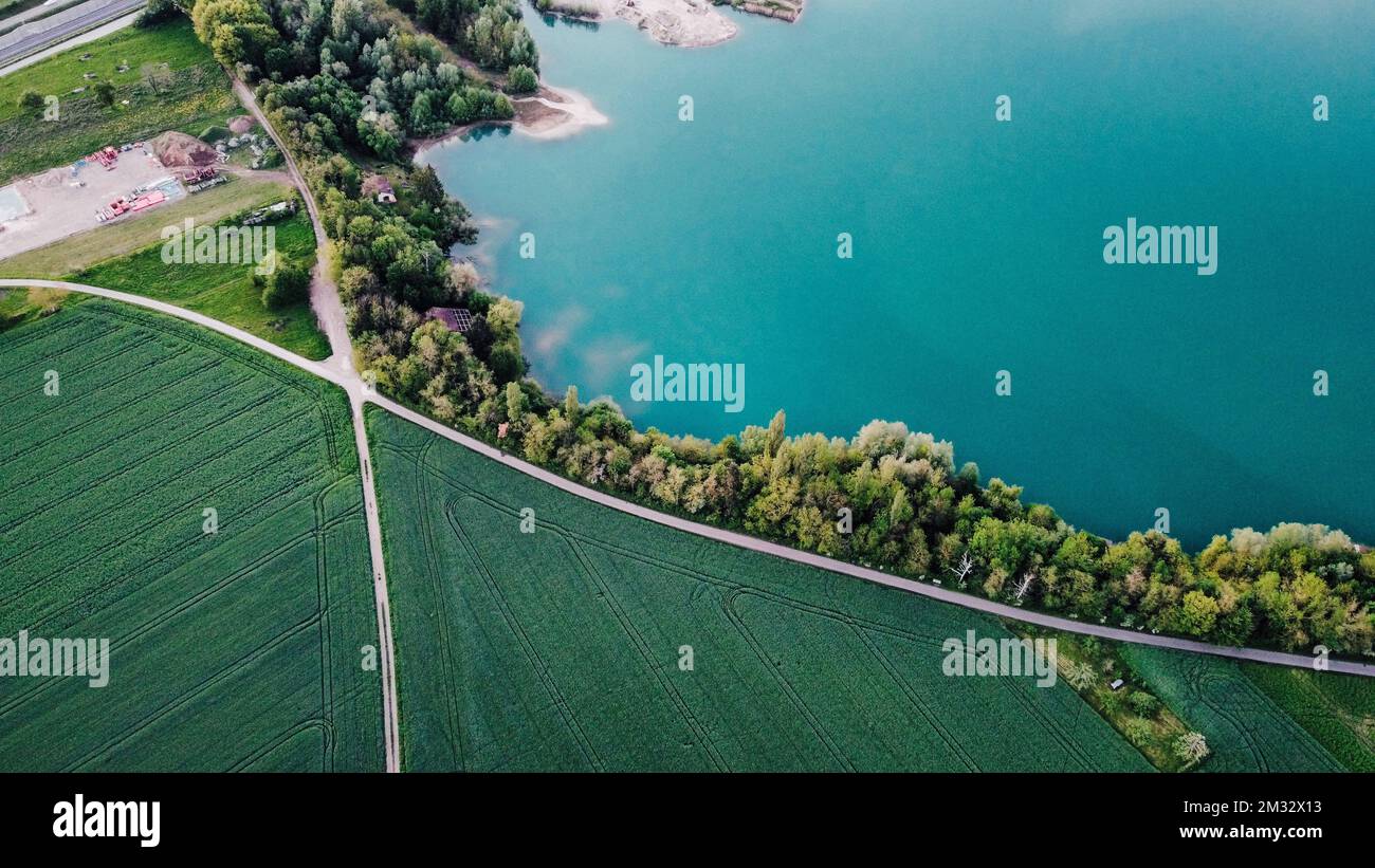 An aerial view of a landscape with lake and trees around Stock Photo ...