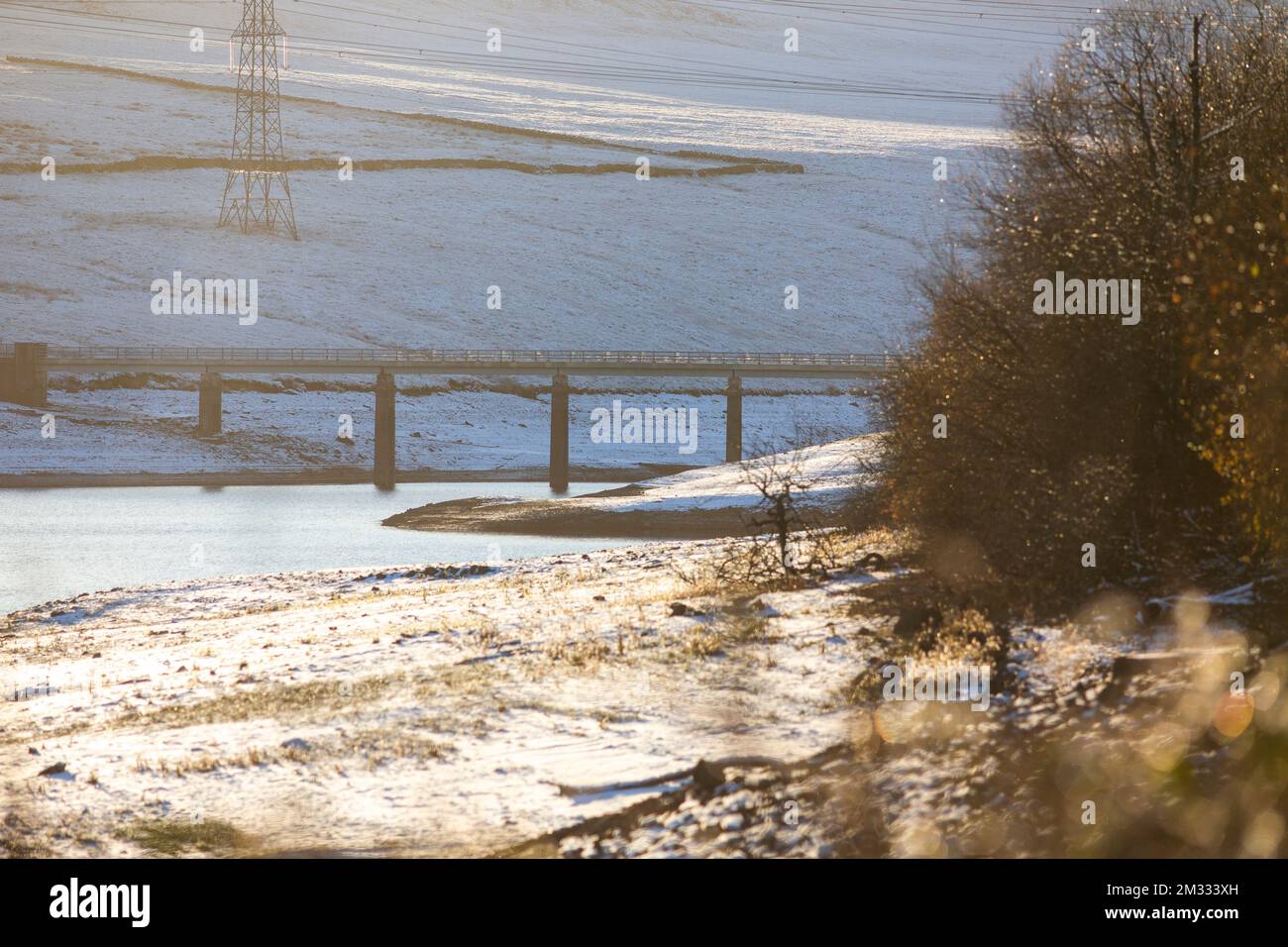 Baitings Reservoir,West Yorkshire, UK. 14th Dec, 2022. UK Weather  Winter scenes around the Yorkshire Water reservoir Baitings near Ripponden, West Yorkshire as the cold snap continues throughout the UK. Levels of the reservoir are still low and the old bridge is still visible in the upper part of it.   Credit: Windmill Images/Alamy Live News Stock Photo