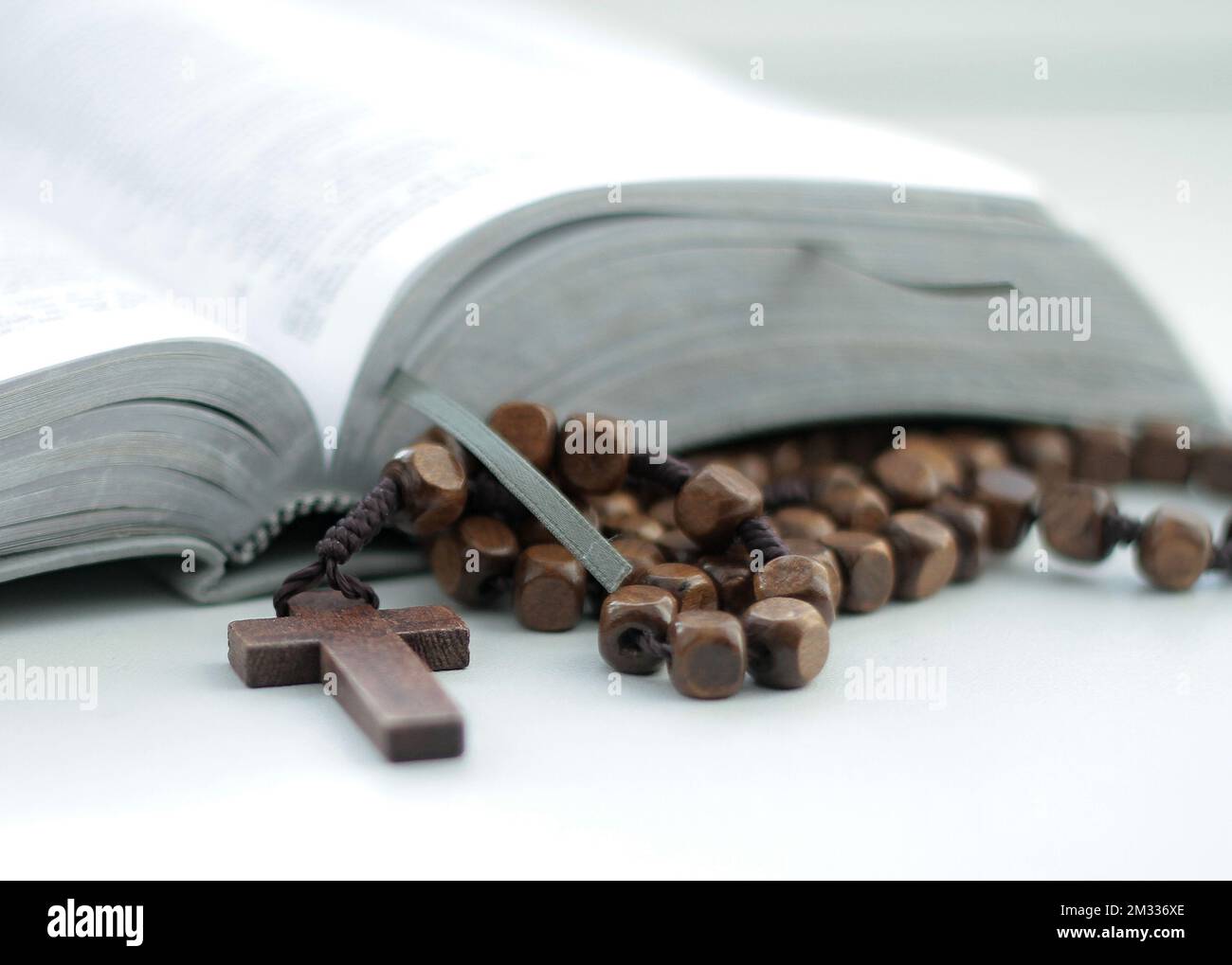 praying with the bible and cross on a table at home no people stock photo Stock Photo