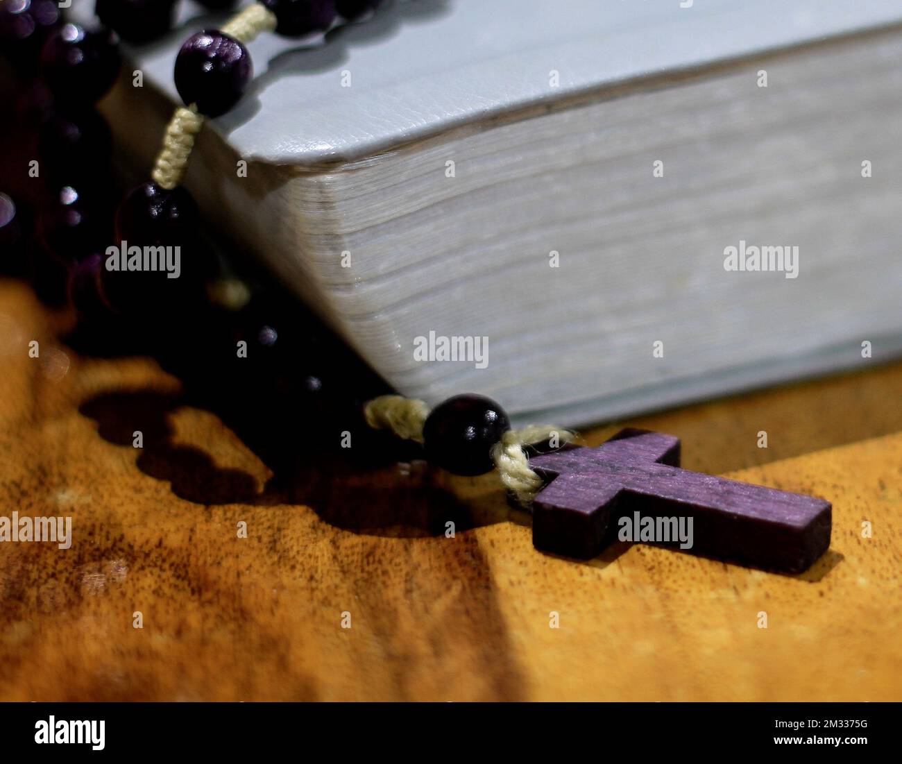 praying with the bible and cross on a table at home no people stock photo Stock Photo