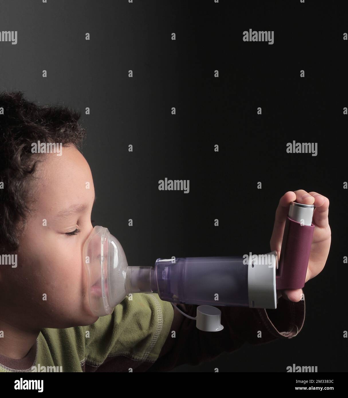 child with flu and inhaler respiratory puff on grey background with