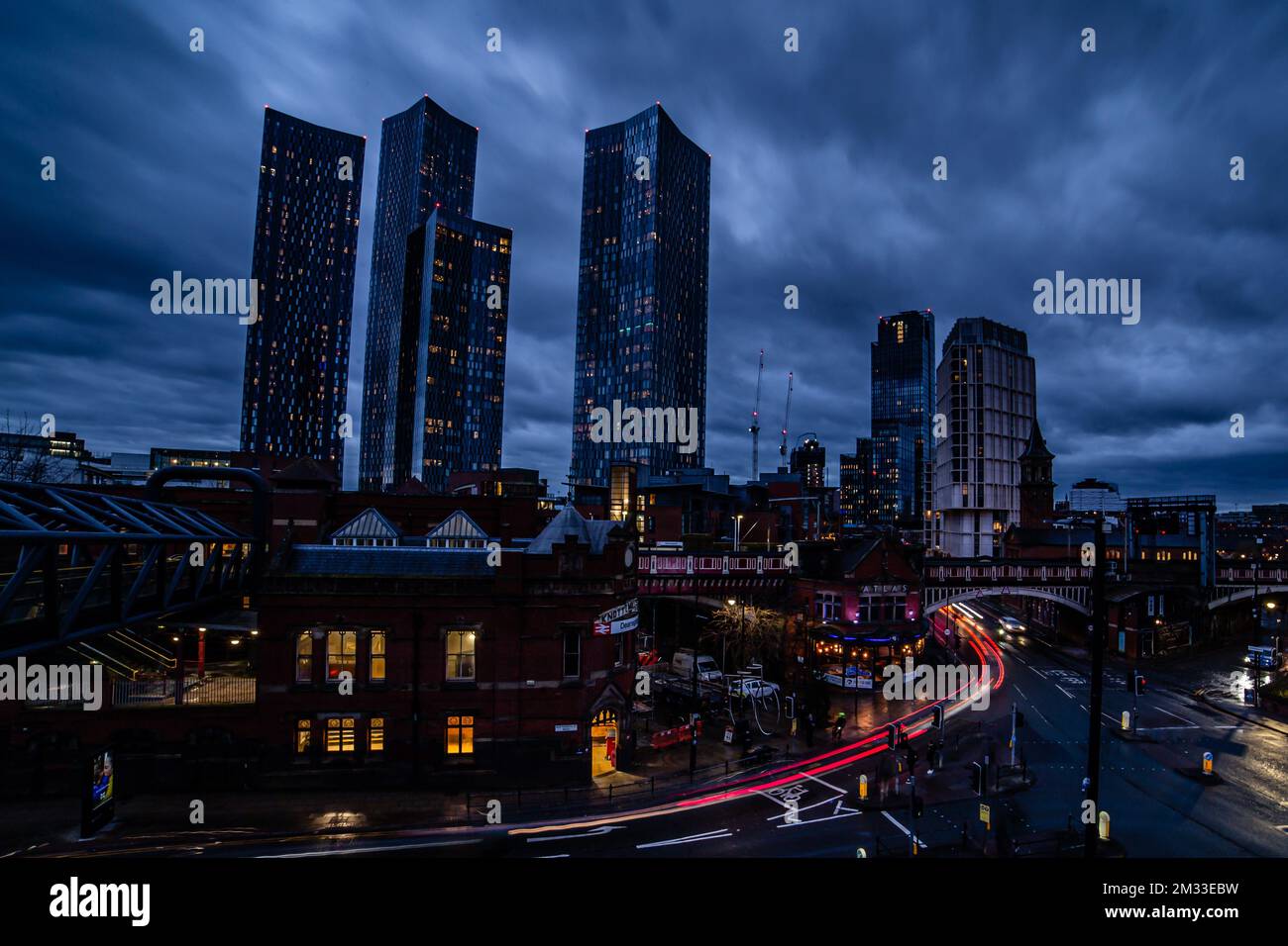 A night view of Deansgate Square with four skyscraper towers under the cloudy sky Stock Photo