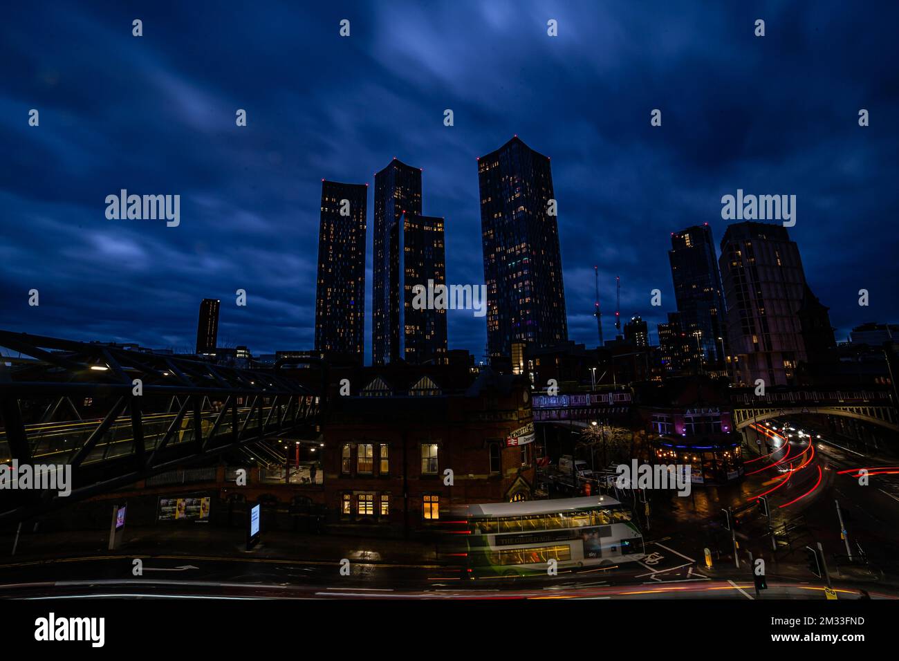 A night view of Deansgate Square with its four skyscraper towers under the cloudy sky Stock Photo