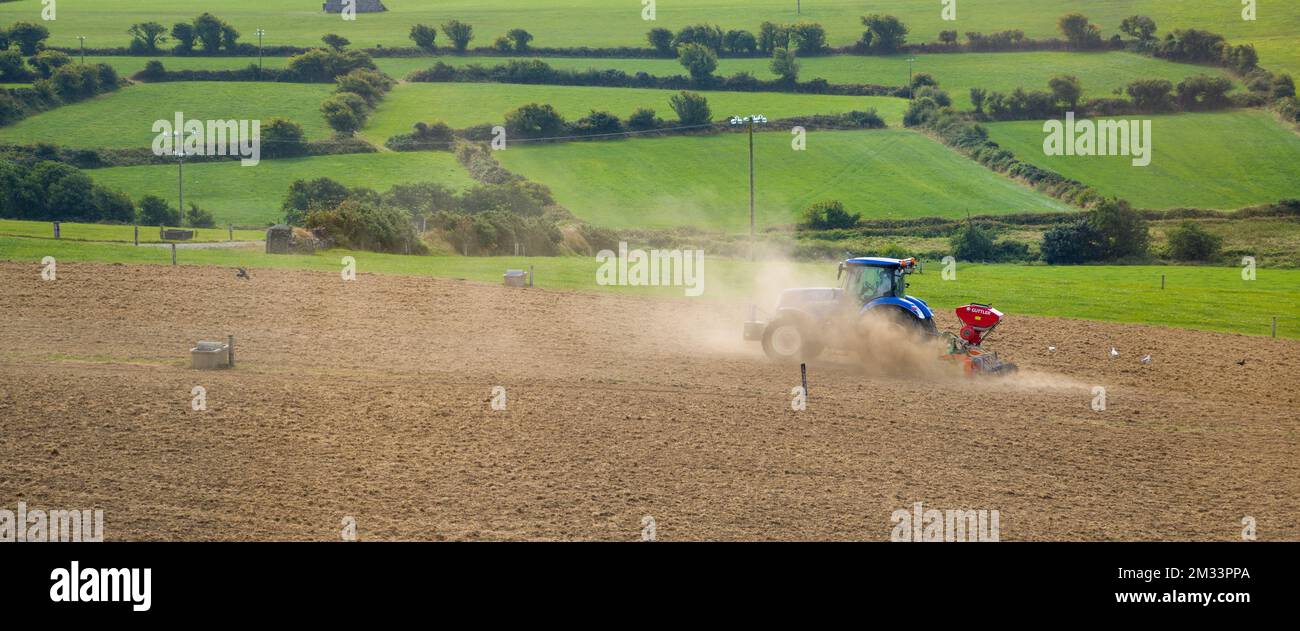 West Cork, Ireland, August 20, 2022. A tractor sows a plowed field on a