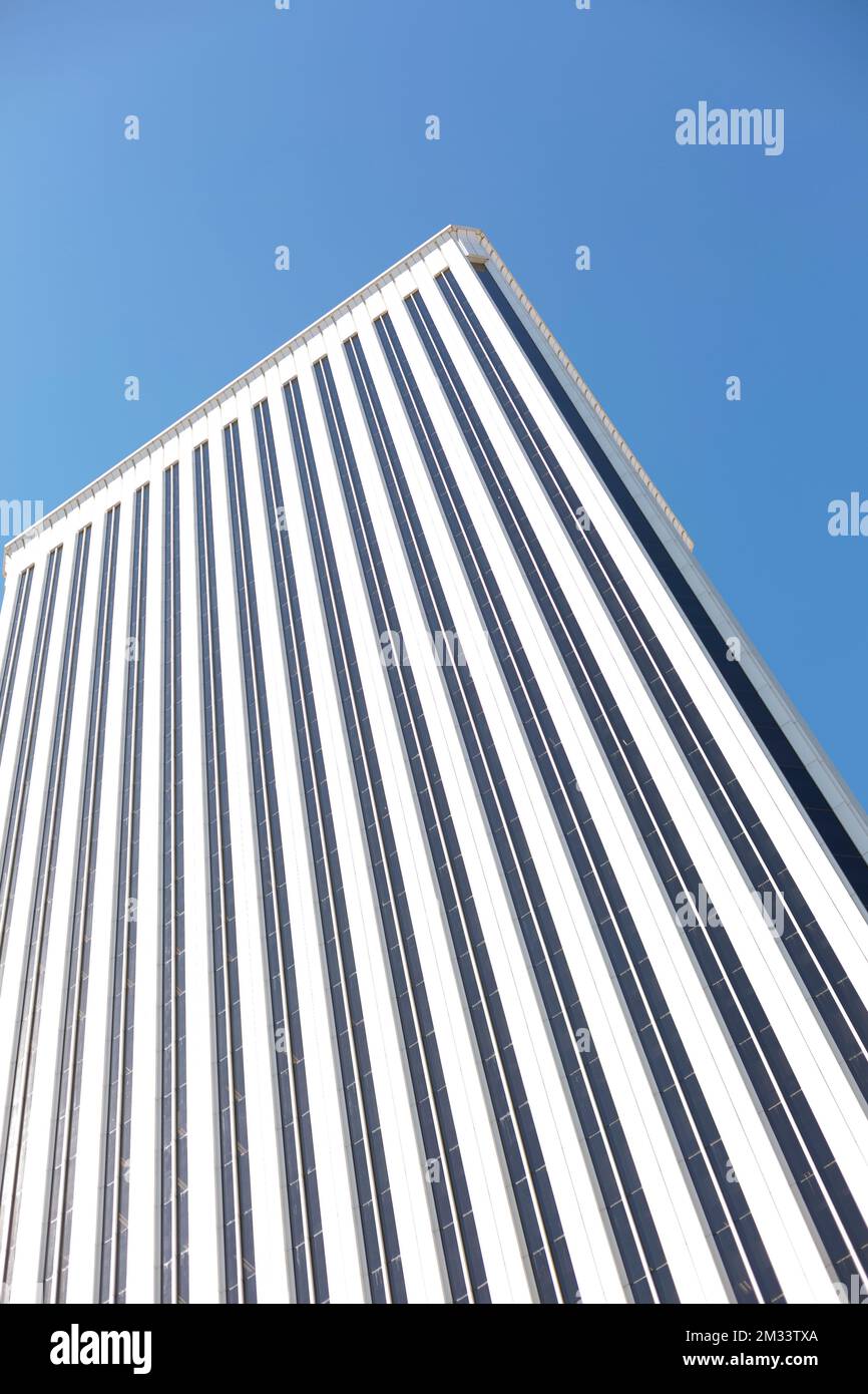 View of the exterior of an imposing office building with clear blue sky. Architecture and business concept. Stock Photo