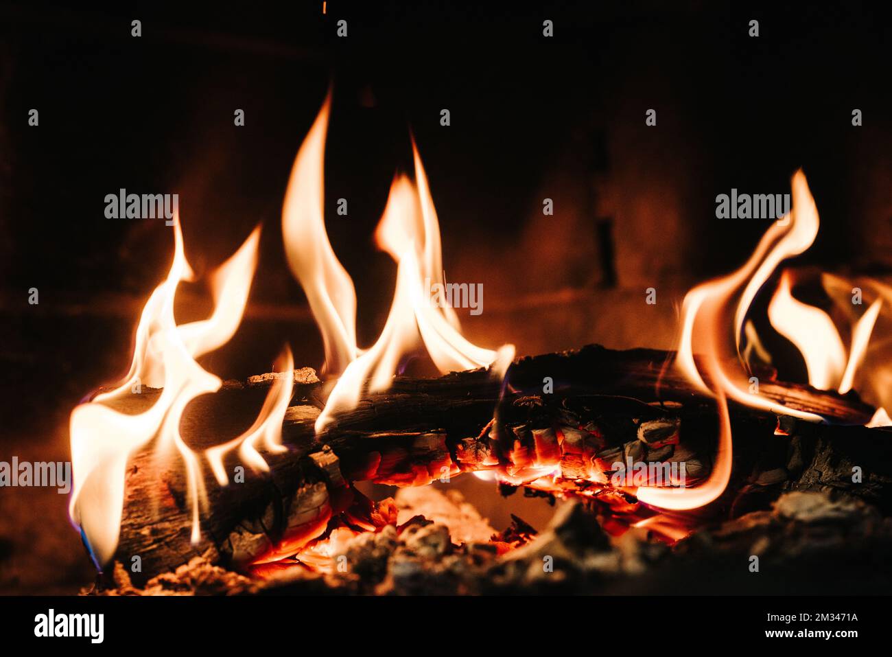 burning smoldering fire in a stone fireplace at home Stock Photo Alamy