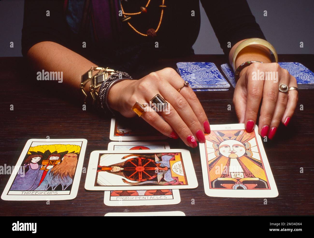 Closeup of tarot card reader clipping over cards Stock Photo