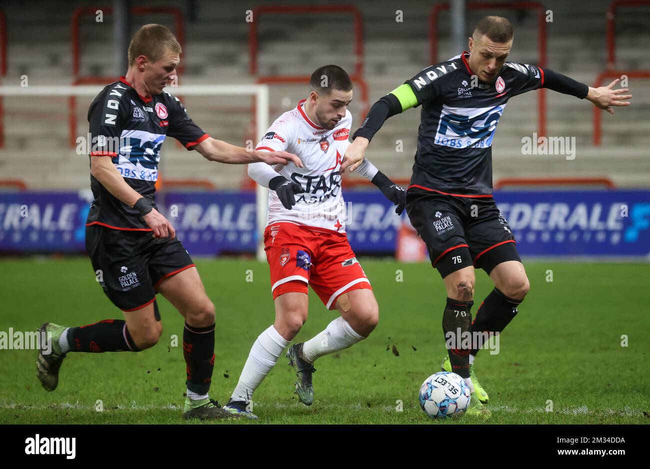Kortrijk's Abdul Ajagun, Mouscron's Bruno Xadas Alexandre Vieira Almeida and Kortrijk's Timothy Derijck fight for the ball during a soccer match between Royal Excel Mouscron and KV Kortrijk, Friday 05 February 2021 in Mouscron, on day 24 of the 'Jupiler Pro League' first division of the Belgian championship. BELGA PHOTO VIRGINIE LEFOUR Stock Photo