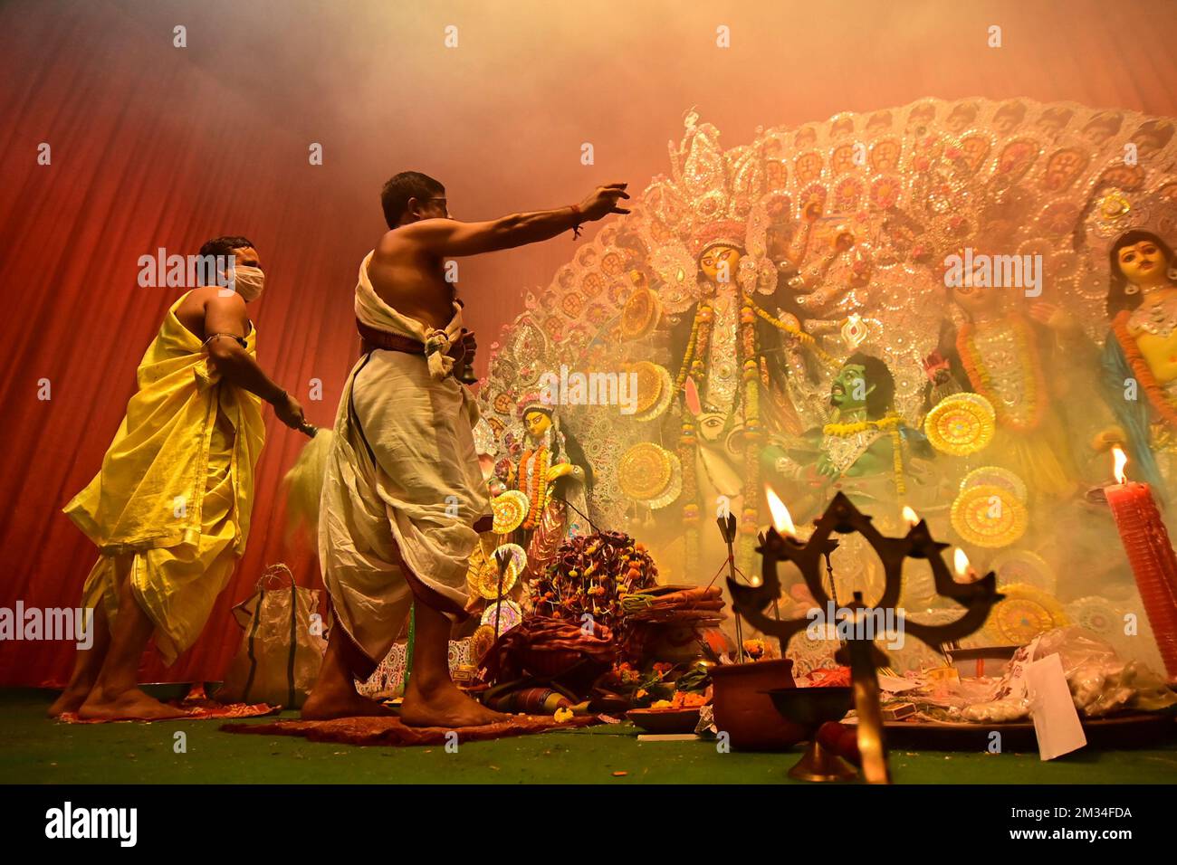 Howrah, West Bengal, India - 13th October 2021 : Goddess Durga is being worshipped by Hindu priests with holy panchapradip, in forground, during ashta Stock Photo