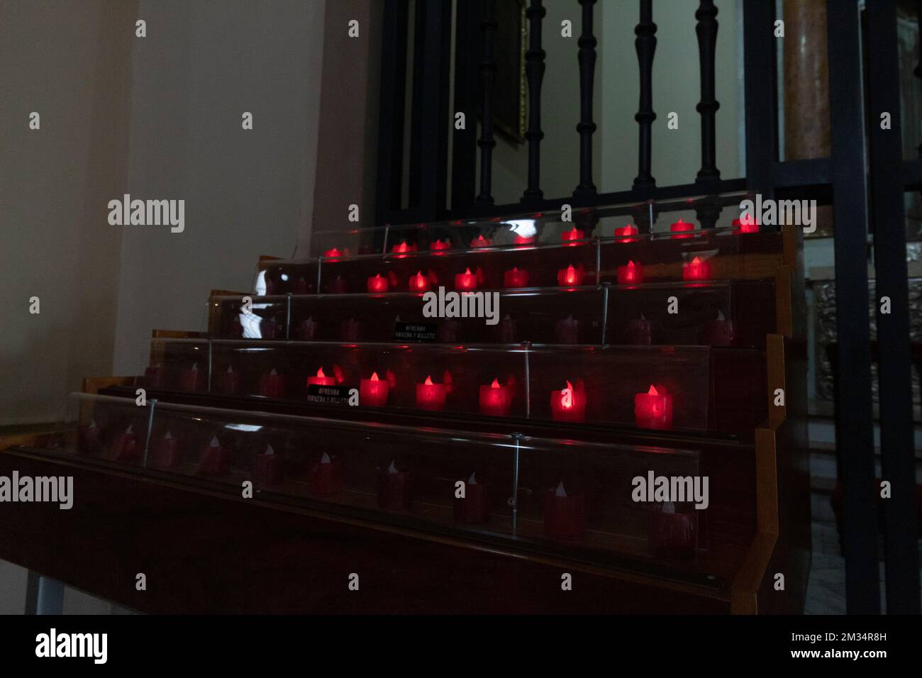 red electric church candles inside primatial cathedral at downtown city