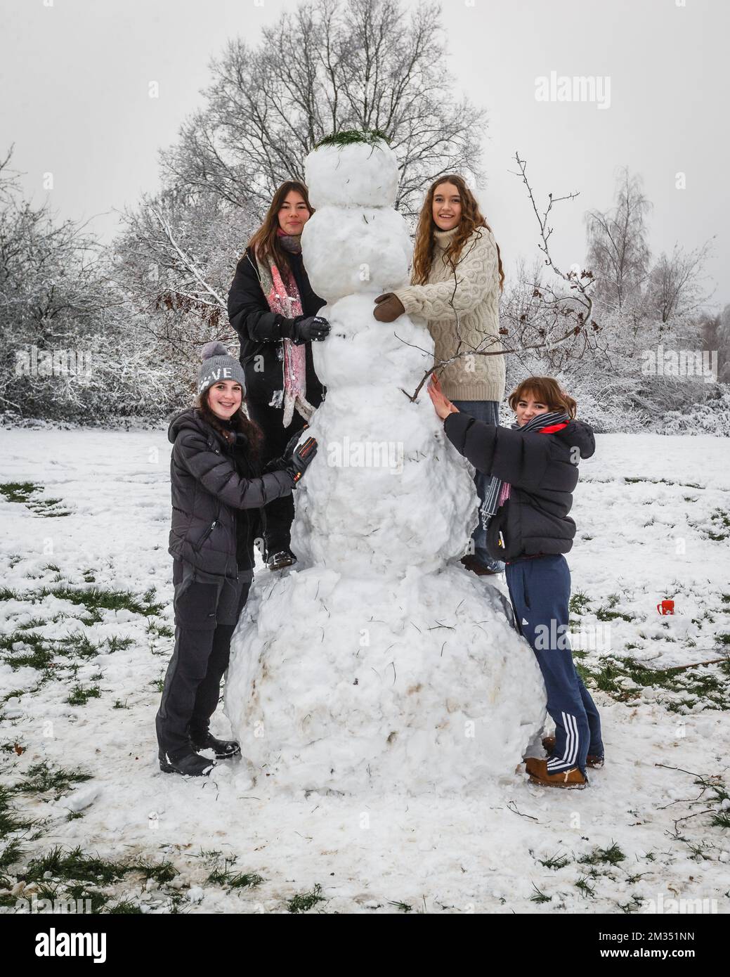 Two hours of snow fun for these teenagers in London's Hampstead to produce this giant snowman. Stock Photo