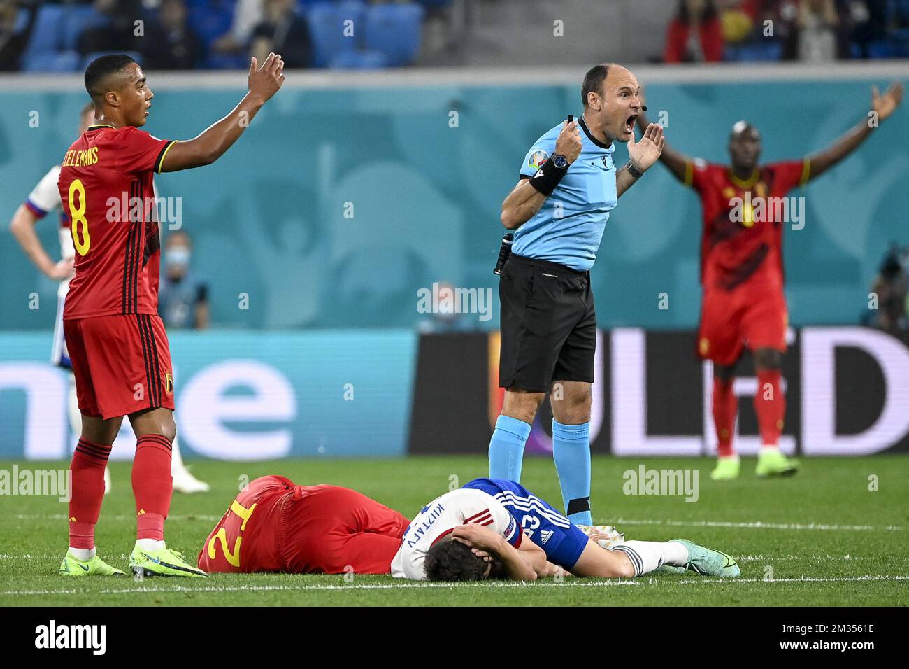 Belgium's Youri Tielemans, Belgium's Timothy Castagne, Russian Daler Kuzyayev and Referee Spanish Antonio Mateu Lahoz pictured during a soccer game between Russia and Belgium's Red Devils, the first game in the group stage (group B) of the 2020 UEFA European Football Championship, on Saturday 12 June 2021 in Saint Petersburg, Russia. BELGA PHOTO DIRK WAEM Stock Photo