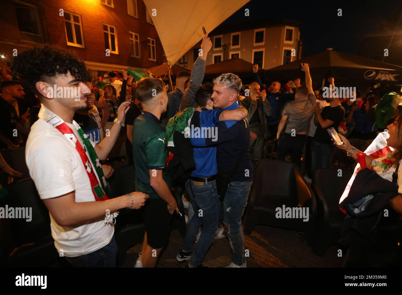 Illustration shows Italian supporters chearing after Italy wins the game in the city center of La Louviere, during the quarter final game of the Euro 2020 European Championship between the Belgian national soccer team Red Devils and Italy, in Munich, Germany, Friday 02 July 2021. BELGA PHOTO NICOLAS MAETERLINCK  Stock Photo