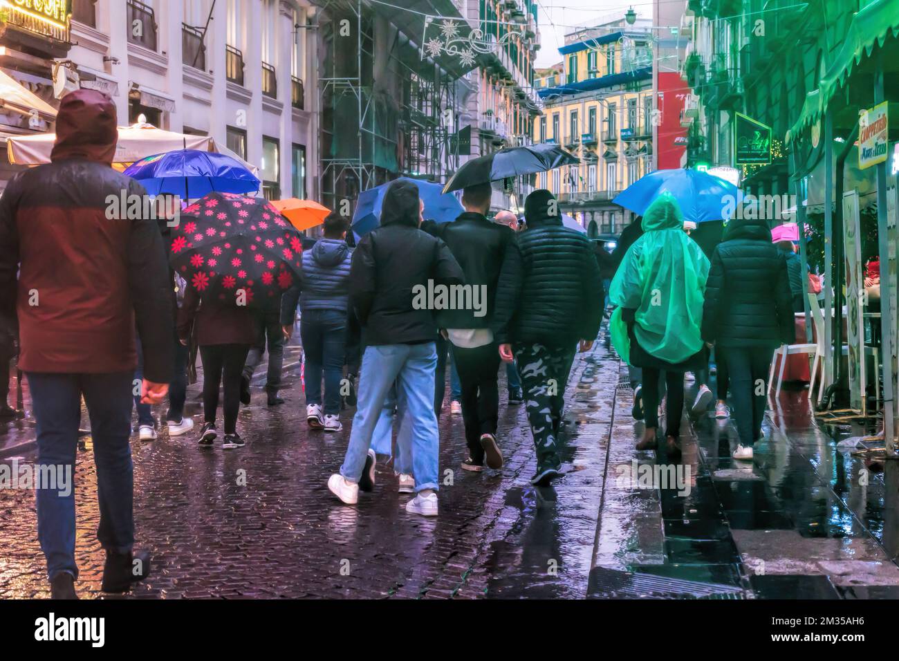 Naples, Italy - December 10, 2022: On a rainy day people stroll in via Toledo, the street is crowded in the pre-Christmas period. Stock Photo