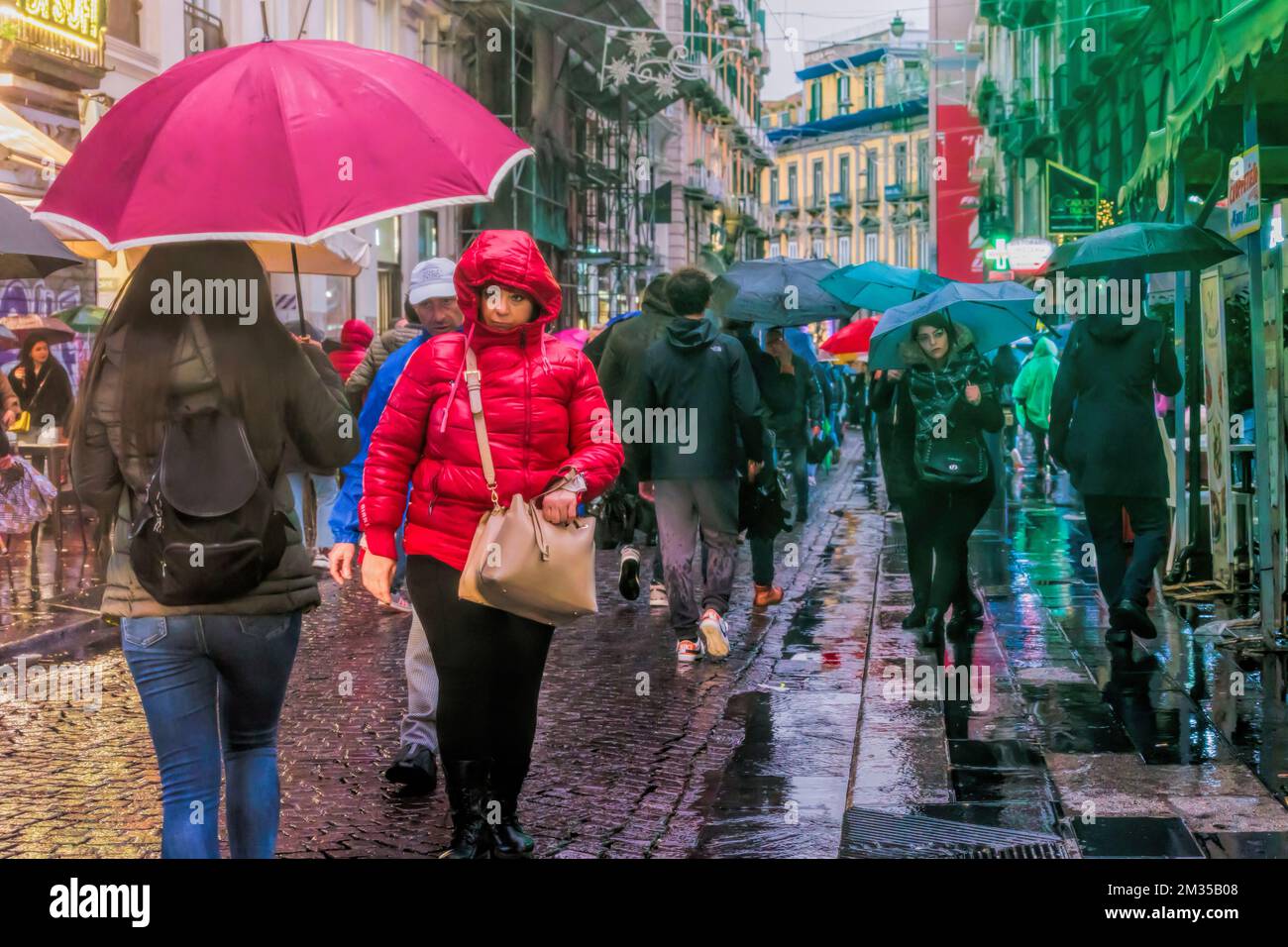 Naples, Italy - December 10, 2022: On a rainy day people stroll in via Toledo, the street is crowded in the pre-Christmas period. Stock Photo