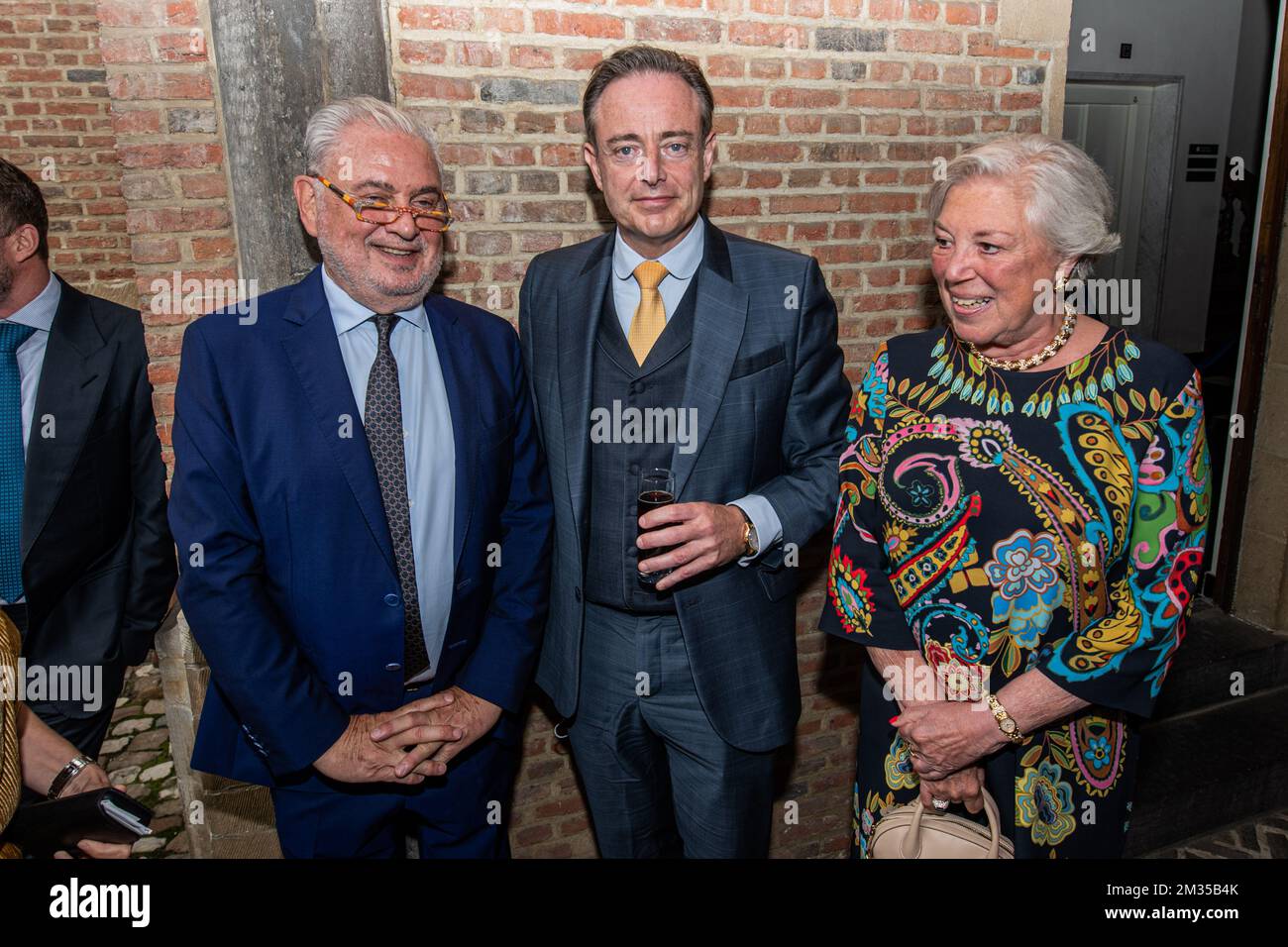Antwerp Mayor Bart De Wever (C), Katoen Natie CEO Fernand Huts (L) and Huts' wife Karine (R) pictured during the key handover of the iconic 'Boerentoren' KBC tower in the center of Antwerp, Sunday 11 July 2021. Original owner KBC Bank sold the landmark building, built in 1930 in Art-Deco style, to Katoen Natie Group. The tower will be turned into a 'Culture Tower', with room for shops, offices and homes. The reconstruction and conversion will take some 6 years. BELGA PHOTO JONAS ROOSENS Stock Photo