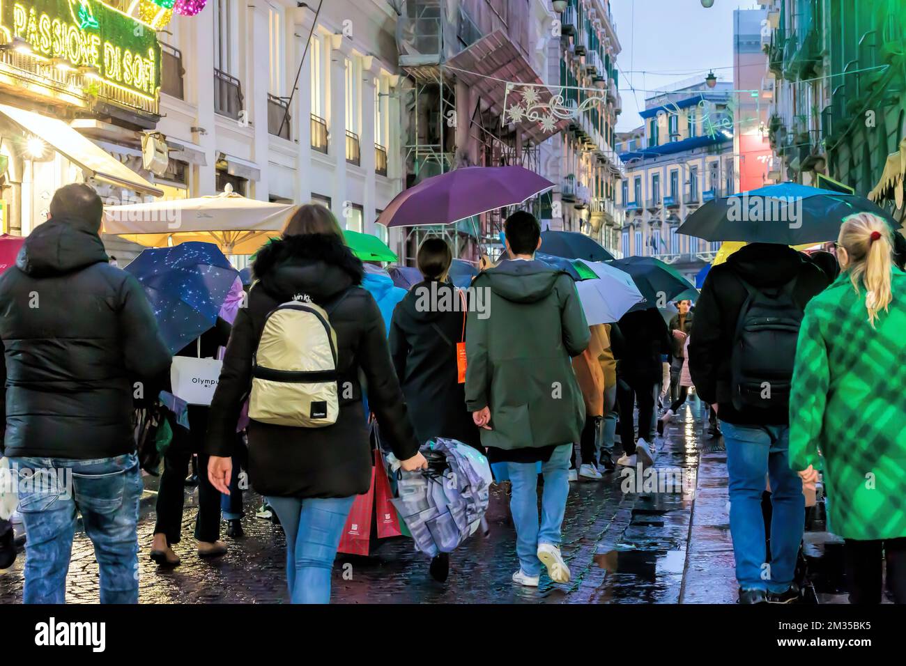 Naples, Italy - December 10, 2022: On a rainy day people stroll in via Toledo, the street is crowded in the pre-Christmas period. Stock Photo