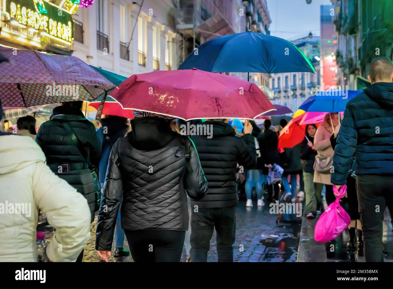 Naples, Italy - December 10, 2022: On a rainy day people stroll in via Toledo, the street is crowded in the pre-Christmas period. Stock Photo