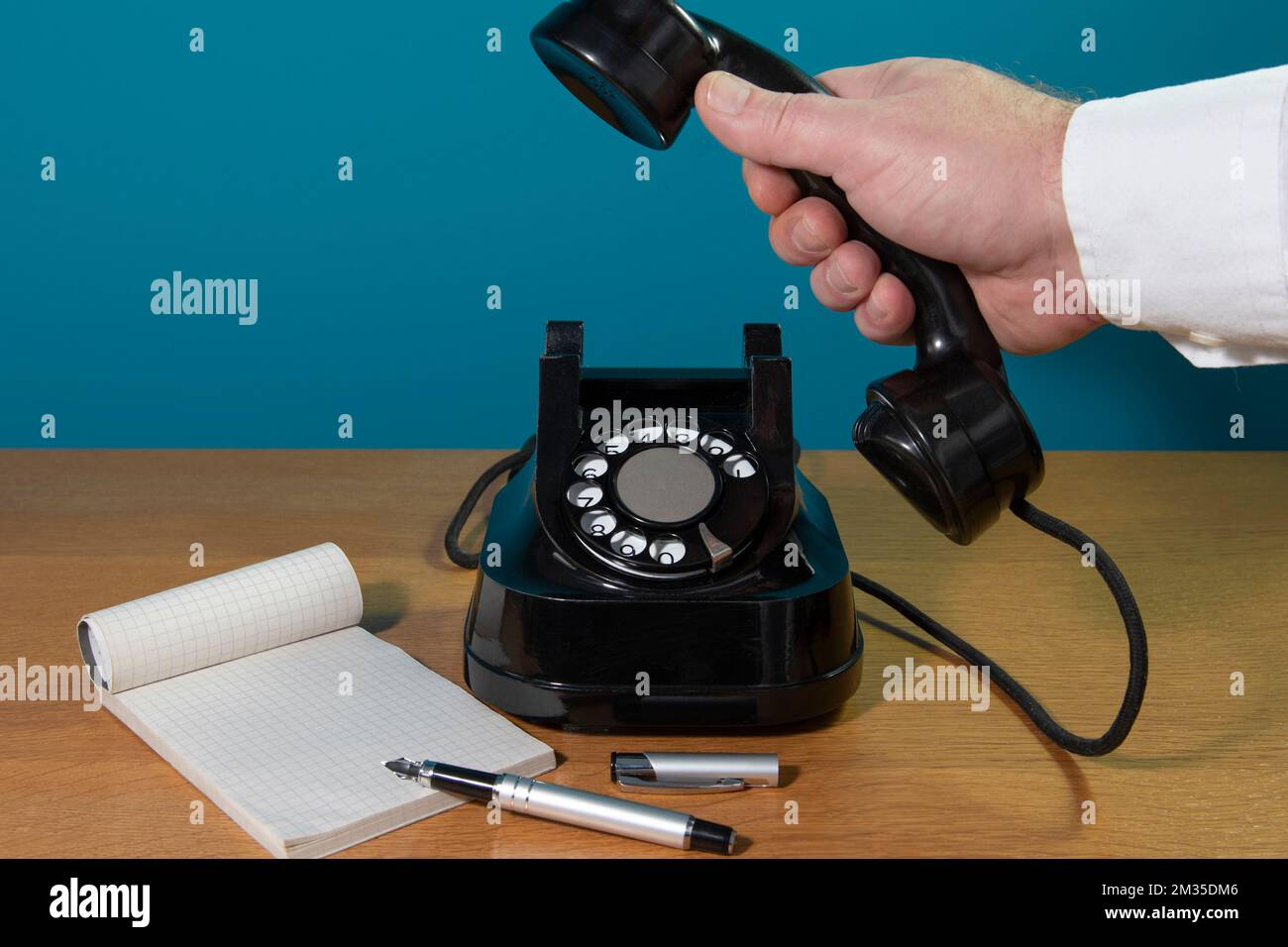 old black telephone on the table. dialing, notebook, ink pen. Copy space Stock Photo