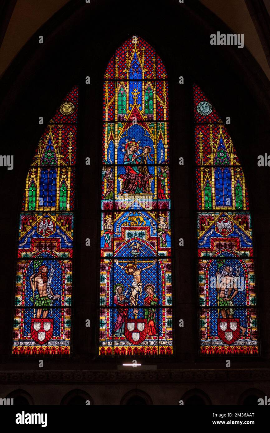A vertical shot of a stained glass window of the Freiburger Munster cathedral in Germany Stock