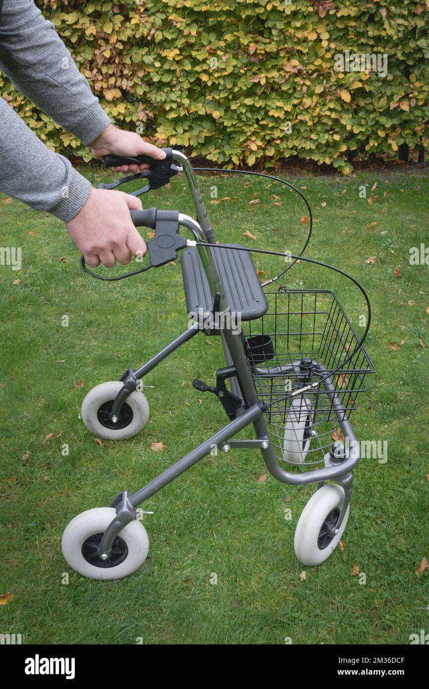 Using Rollator Walker outside Man holding handles Stock Photo Alamy