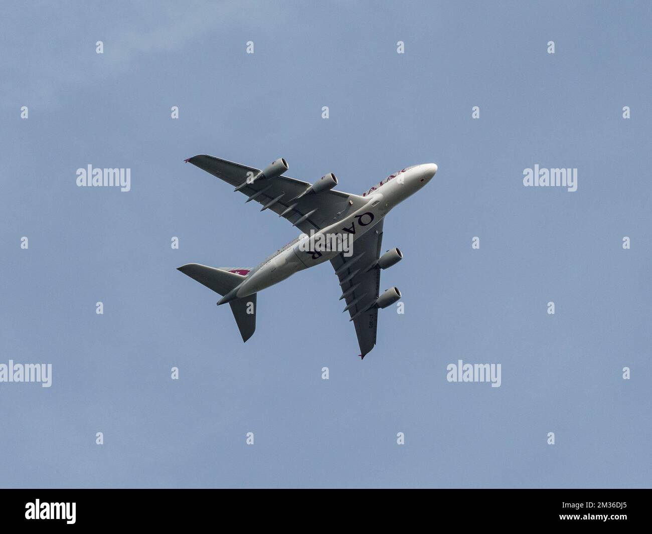 A Qatar Airways Airbus A380-800 (A7-APD) viewed from underneath departing from London Heathrow Airport UK. Stock Photo