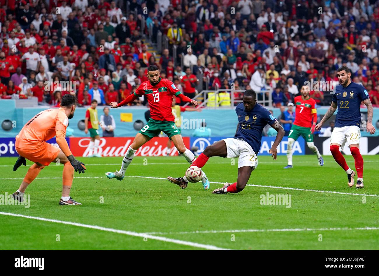 France's Ibrahima Konate (centre) blocks Morocco's Youssef En-Nesyri from scoring during the FIFA World Cup Semi-Final match at the Al Bayt Stadium in Al Khor, Qatar. Picture date: Wednesday December 14, 2022. Stock Photo