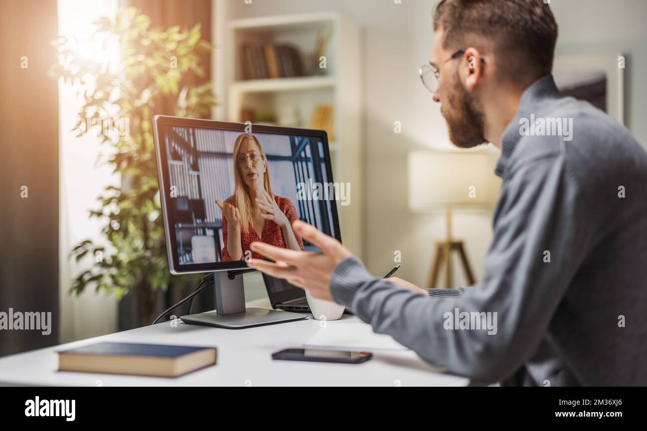Man on videocall with colleague Stock Photo