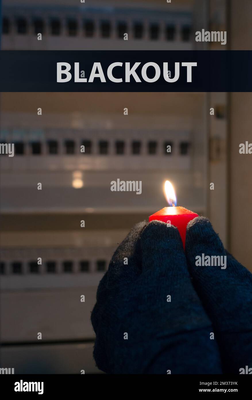 Blackout, standing with a candle in front of a power fuse box, energy