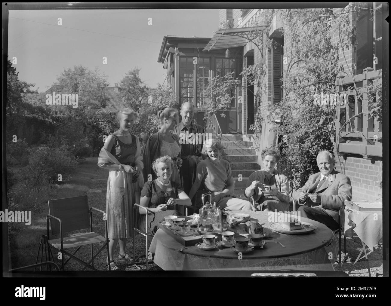 Group having tea in garden , Eating & drinking, Tea, Gardens. Samuel